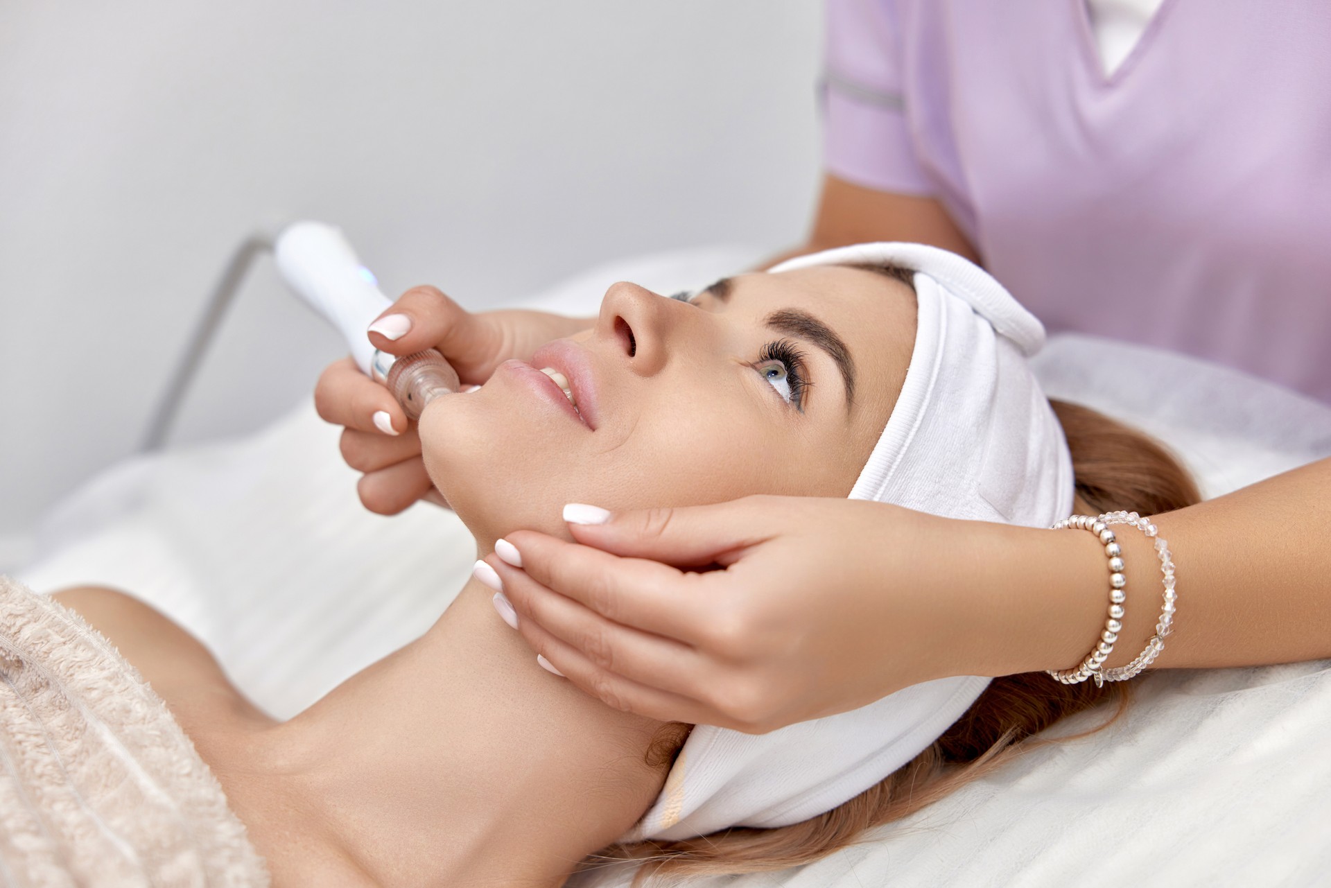 cosmetologist doing anti aging procedure in salon